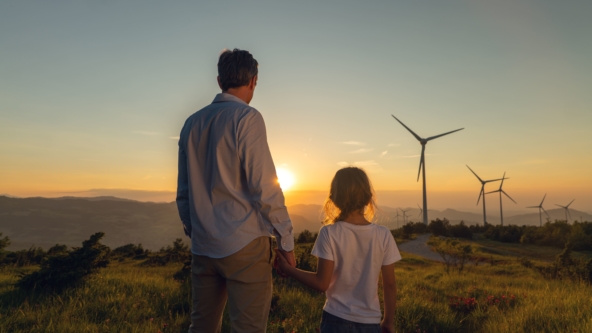 Man and child overlooking a wind farm